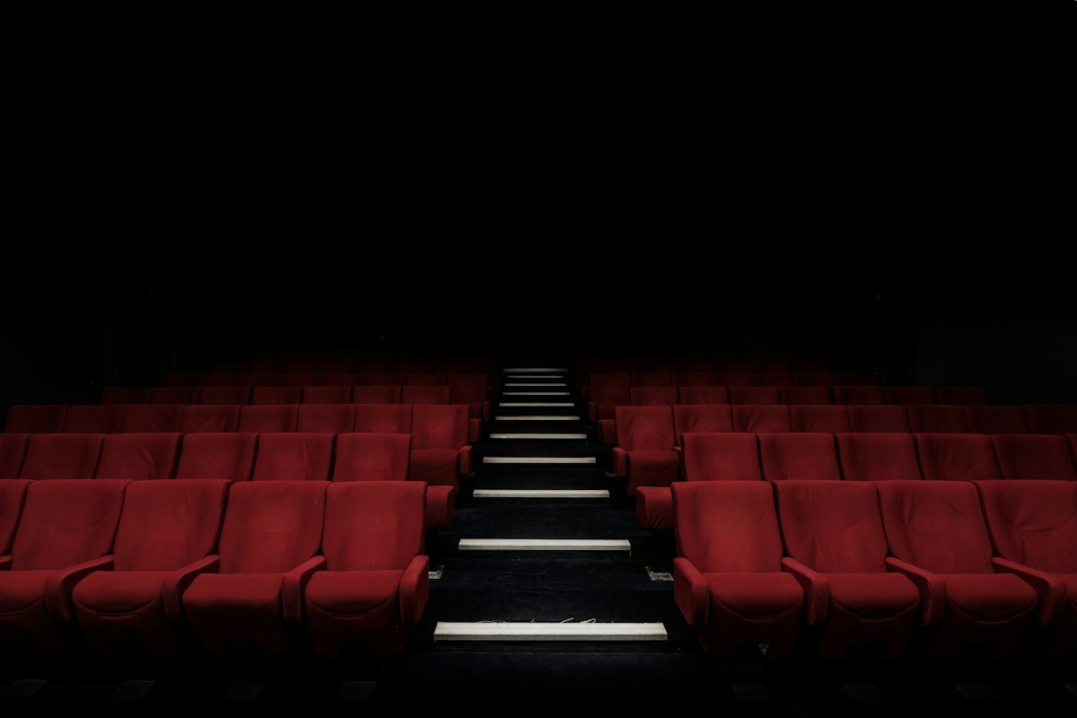 Empty cinema auditorium with red seats