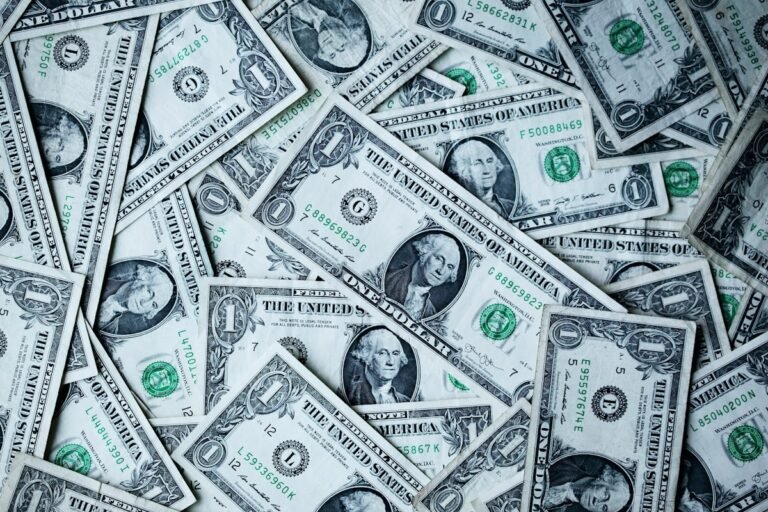 Hands holding money and a plant for savings