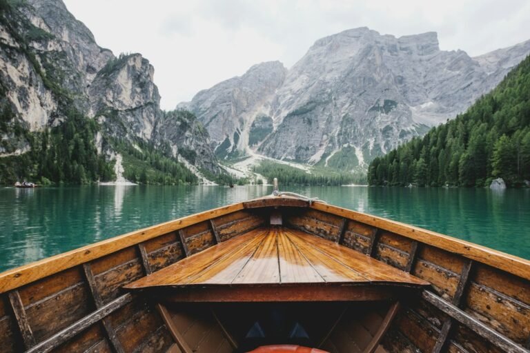 Red canoe floating on a turquoise mountain lake