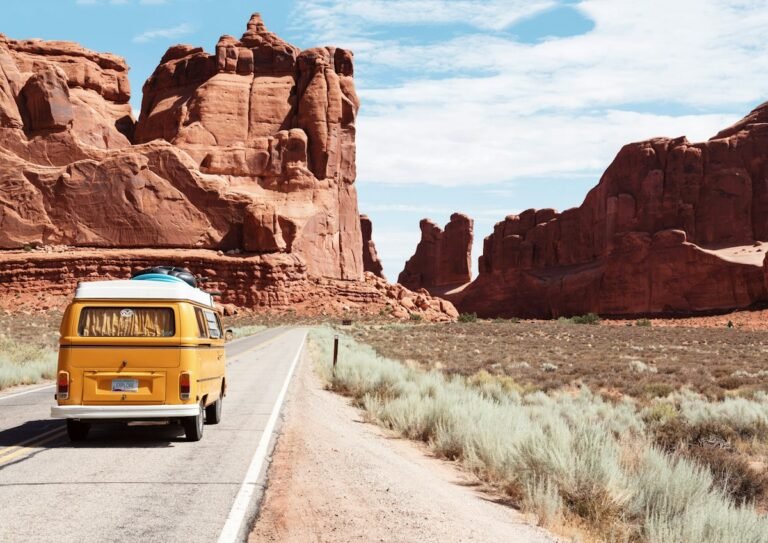 Car driving on an open desert road during a road trip