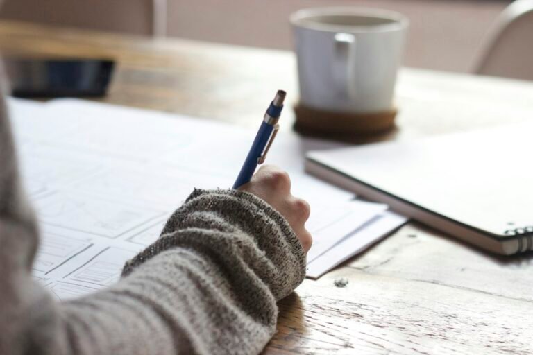 Student writing study notes in a notebook