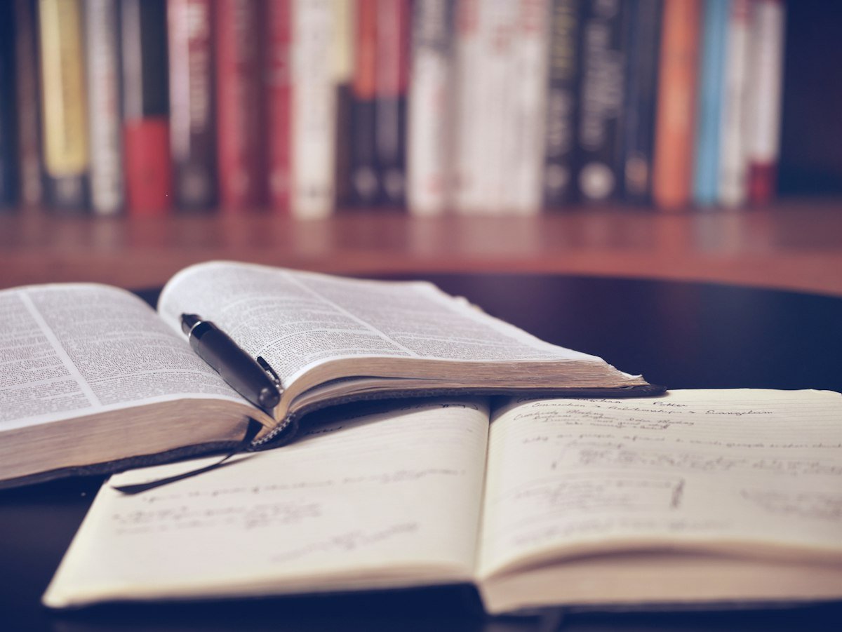 Tidy study desk with books, notebook and stationery