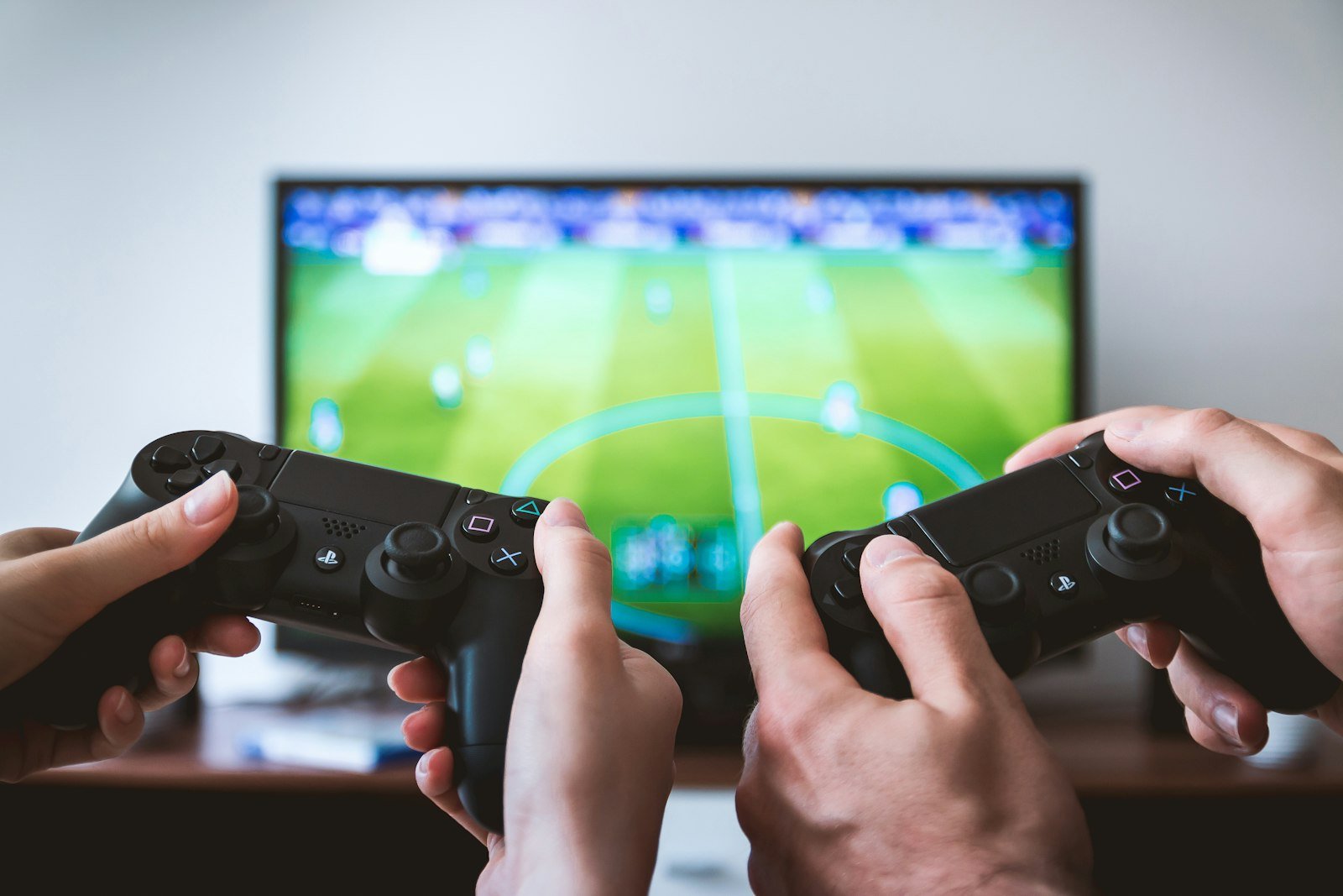 Friends sharing exciting video game news stories during a gaming session